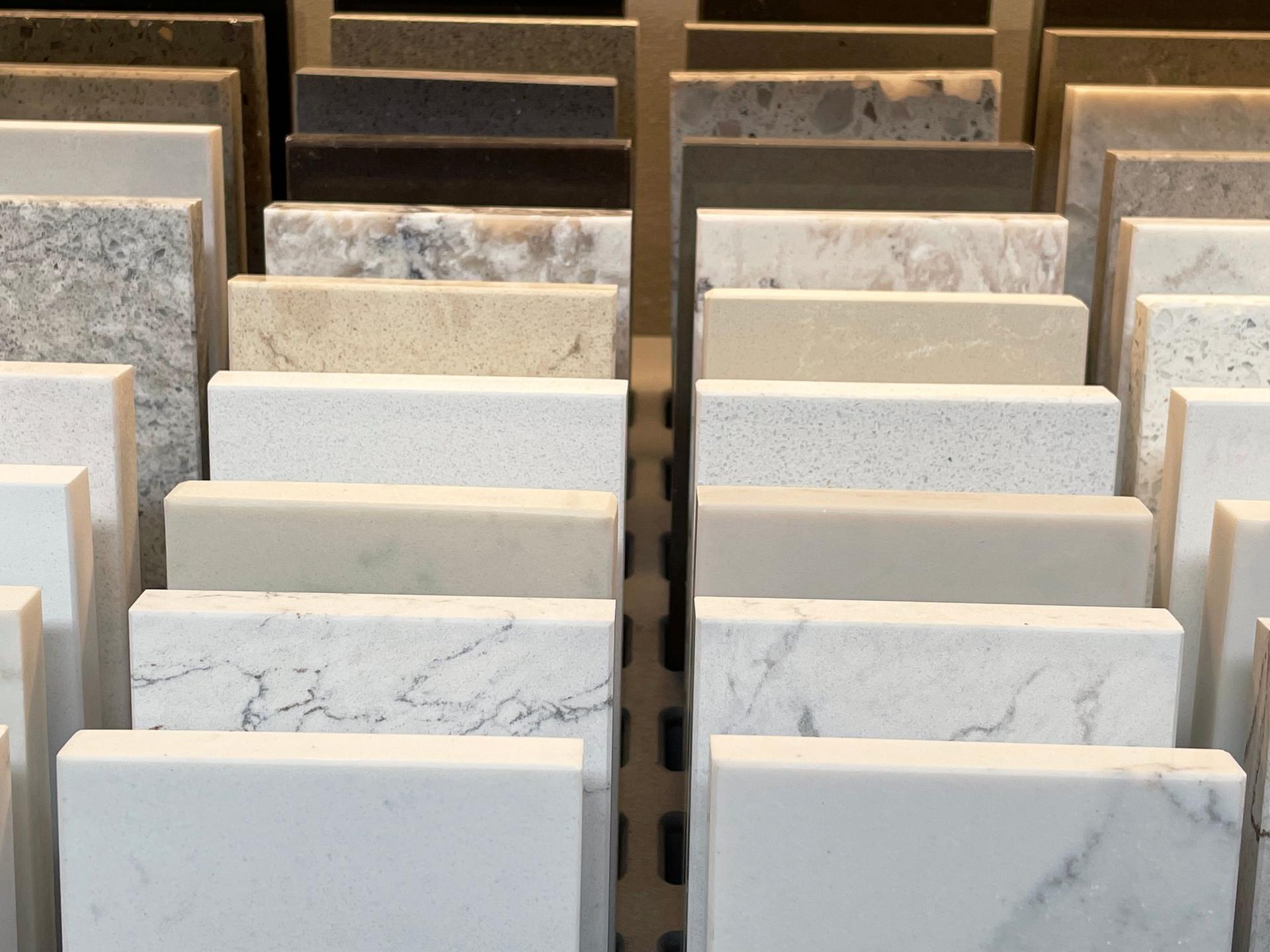 Close-up image of stacks of tile samples in rows, natural stone tiles, granite, limestone, marble, slate and travertine