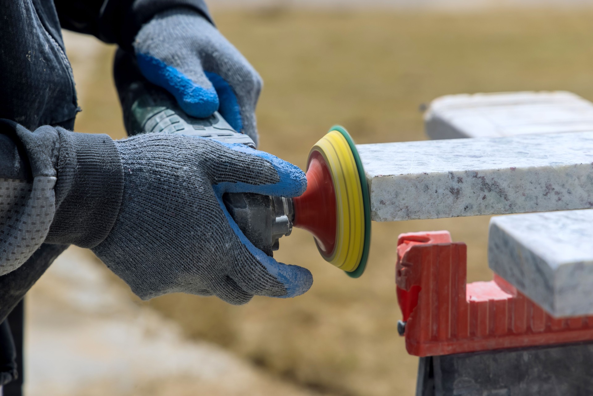 Master use a sander tool for polished granite stone